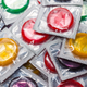 An image of colorful condoms in their wrappers.